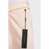 Beige cropped trousers with tag