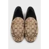 Brown loafers with a signature print