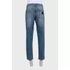 Men's blue distressed jeans with a zipper