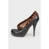 Leather black ankle boots with a leopard fur insert