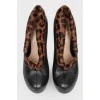 Leather black ankle boots with a leopard fur insert