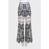Beige straight-leg trousers with a print