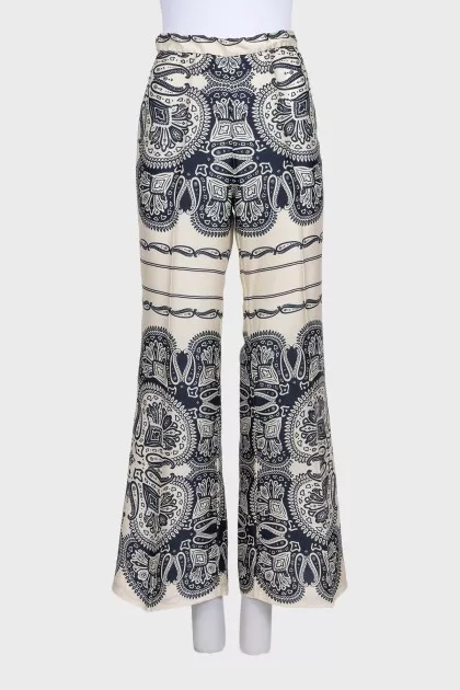 Beige straight-leg trousers with a print