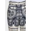 Beige straight-leg trousers with a print
