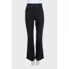 Flared jeans with gold buttons on the side