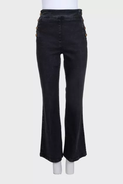 Flared jeans with gold buttons on the side