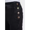 Flared jeans with gold buttons on the side