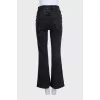 Flared jeans with gold buttons on the side