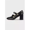 Black leather shoes with gold decor