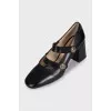 Black leather shoes with gold decor