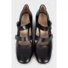 Black leather shoes with gold decor