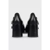 Black leather shoes with gold decor