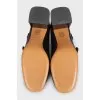 Black leather shoes with gold decor