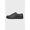 Black leather sneakers on lacing