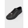 Black leather sneakers on lacing