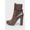 Leather brown boots with a strap