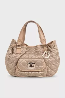 Beige fabric bag with a branded pendant