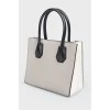 Gray leather bag with white inserts