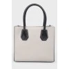 Gray leather bag with white inserts