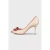 Beige leather shoes with red trim