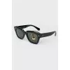 Rectangular black sunglasses with tag
