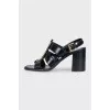 Black leather sandals with gold decor