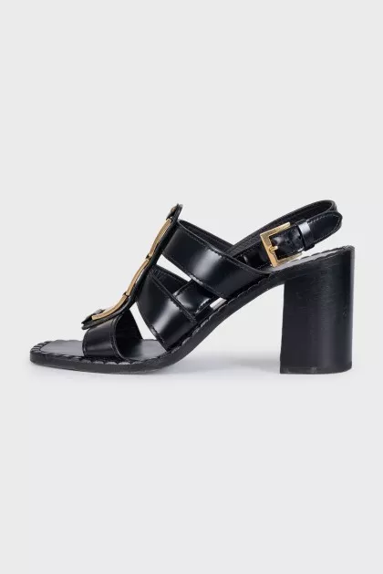 Black leather sandals with gold decor