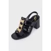 Black leather sandals with gold decor
