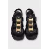Black leather sandals with gold decor