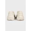 Beige leather sneakers with logo