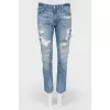 Blue jeans with scuffs and decorative slots