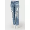 Blue jeans with scuffs and decorative slots
