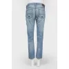 Blue jeans with scuffs and decorative slots