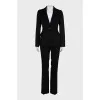 A suit consisting of a fitted jacket and straight trousers