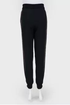 Black trousers with red and black stripes