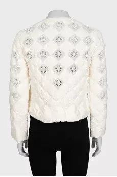 Straight jacket decorated with perforations