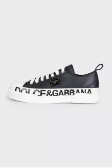 Black leather sneakers with a signature logo