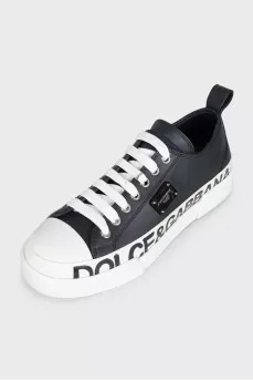 Black leather sneakers with a signature logo