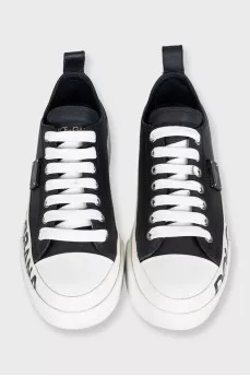 Black leather sneakers with a signature logo