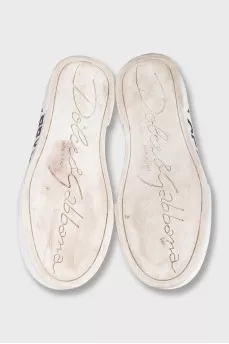 Black leather sneakers with a signature logo