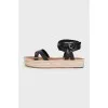 Black leather sandals with a woven sole