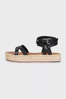 Black leather sandals with a woven sole
