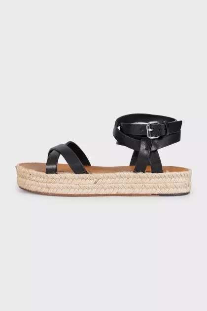 Black leather sandals with a woven sole