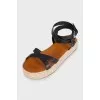 Black leather sandals with a woven sole