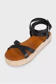 Black leather sandals with a woven sole