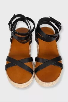 Black leather sandals with a woven sole