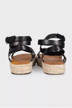 Black leather sandals with a woven sole