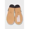 Black leather sandals with a woven sole