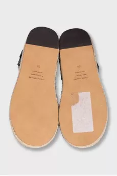 Black leather sandals with a woven sole