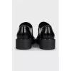 Black leather loafers with logo